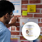 A man is organizing notes using magnets on a magnetic wall - Magnetic Plaster